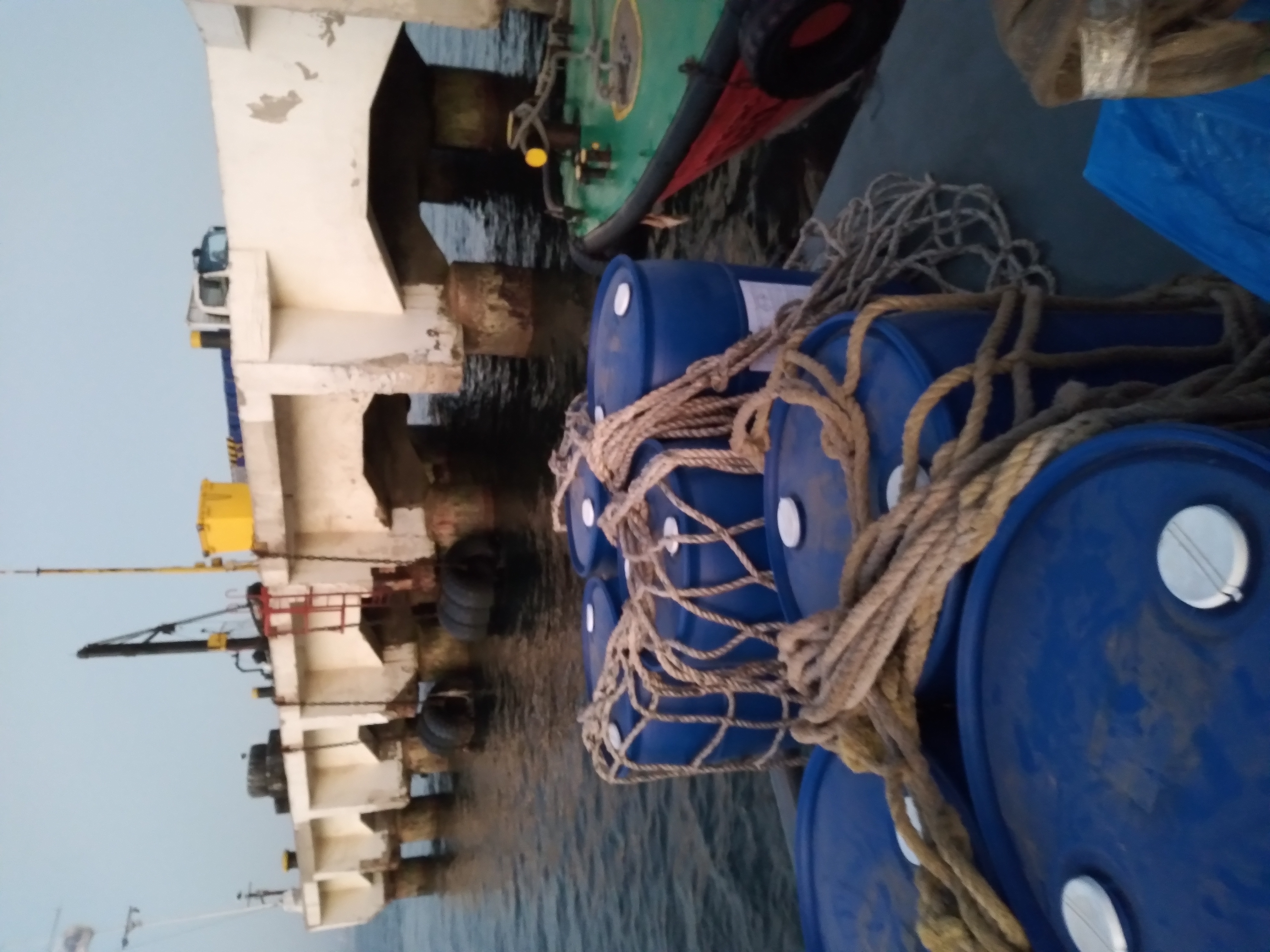 Chemical drums loaded onto supply boat