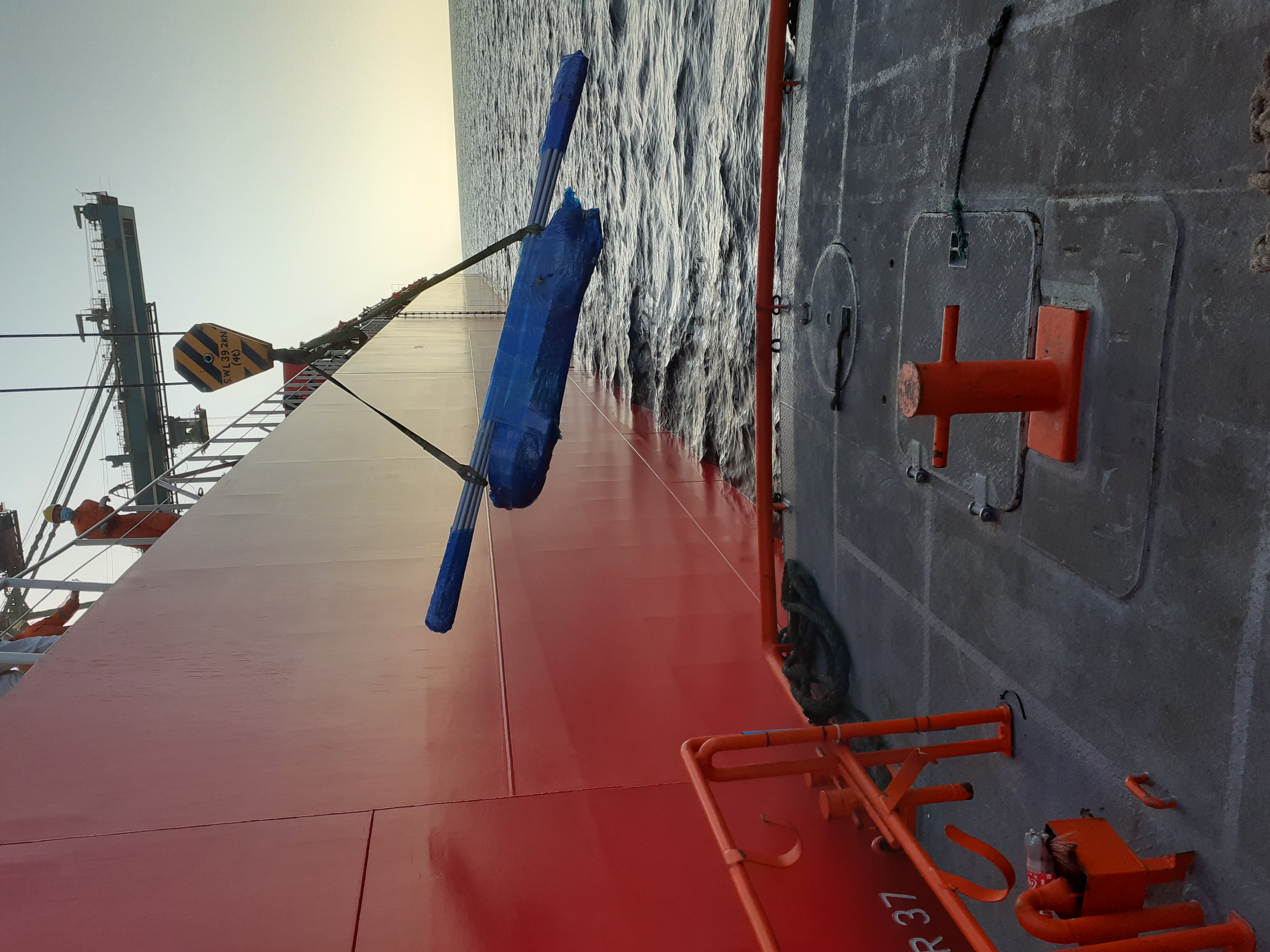 Pipes delivered by crane to vessel